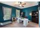 Bright bedroom with two windows features a ceiling fan and dedicated computer work station at 4685 Prater Se Way, Smyrna, GA 30080