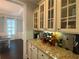 Well-appointed butler's pantry featuring granite counters, stylish wine racks, and cabinetry, convenient to dining and kitchen at 4685 Prater Se Way, Smyrna, GA 30080