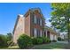 Traditional two-story brick home with manicured lawn, professional landscaping and attached garage at 4685 Prater Se Way, Smyrna, GA 30080