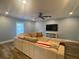 Inviting living room with a large sectional sofa, ceiling fan, and entertainment center at 4685 Prater Se Way, Smyrna, GA 30080