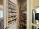 Walk-in pantry with custom shelving and spice racks, providing ample storage and organization for all your culinary needs at 4685 Prater Se Way, Smyrna, GA 30080