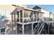 Covered and screened-in porch with stairs, offers a relaxing outdoor space with shade and an entertaining area at 4685 Prater Se Way, Smyrna, GA 30080