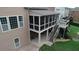 View of the screened porch and backyard featuring a stone paver patio and lush lawn at 4685 Prater Se Way, Smyrna, GA 30080