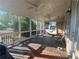 Relaxing screened porch offers outdoor living space with a porch swing, ceiling fans, and a ceiling with tongue-and-groove paneling at 4685 Prater Se Way, Smyrna, GA 30080