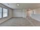 Spacious bonus room with grey carpet and neutral walls at 57 Longhorn Way, Auburn, GA 30011