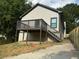 Backyard featuring a wooden deck, green grass, and newly painted exterior at 556 Paines Nw Ave, Atlanta, GA 30318