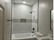 Modern bathroom features a shower-tub combo with stylish white tile and a sleek black shower head at 556 Paines Nw Ave, Atlanta, GA 30318