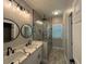 Bright bathroom featuring double vanities and a glass-enclosed shower at 556 Paines Nw Ave, Atlanta, GA 30318