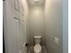 Neutral powder room with a toilet and modern light switch at 556 Paines Nw Ave, Atlanta, GA 30318