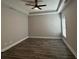A large bedroom with wood floors, tray ceiling, and ceiling fan at 556 Paines Nw Ave, Atlanta, GA 30318