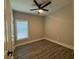 Empty bedroom with hardwood floors, neutral paint, and a ceiling fan that awaits your personal touch at 556 Paines Nw Ave, Atlanta, GA 30318