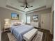 Bedroom features a bed with elegant blue accents and tray ceilings at 556 Paines Nw Ave, Atlanta, GA 30318