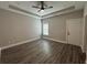 Spacious bedroom featuring a tray ceiling, bright window, and wood-look flooring at 556 Paines Nw Ave, Atlanta, GA 30318