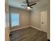 Bedroom features wood-look floors, a ceiling fan, and a bright window at 556 Paines Nw Ave, Atlanta, GA 30318