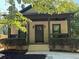 Charming home with a welcoming porch, dark trim, new mulch, and well-maintained landscaping at 556 Paines Nw Ave, Atlanta, GA 30318