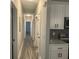 Long hallway with hardwood floors and neutral paint that connects the home's interior at 556 Paines Nw Ave, Atlanta, GA 30318