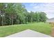 A well-maintained backyard features a lush lawn and mature trees, offering a serene outdoor space at 386 Rock View Ln, Covington, GA 30016