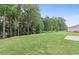 A sprawling backyard with a well-kept lawn, mature trees, and privacy, creates an inviting outdoor oasis at 386 Rock View Ln, Covington, GA 30016