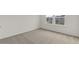 Bedroom featuring neutral carpet, white walls, and natural light from a window at 386 Rock View Ln, Covington, GA 30016