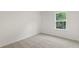 Bedroom with neutral carpet, white walls, and natural light from a window at 386 Rock View Ln, Covington, GA 30016