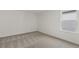 Bedroom with neutral carpet, white walls, and natural light from a window at 386 Rock View Ln, Covington, GA 30016