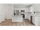 Well-lit kitchen features an island, stainless steel appliances, white cabinets and granite countertops at 386 Rock View Ln, Covington, GA 30016