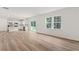Bright living room and kitchen area featuring hardwood floors, granite countertops and stainless steel appliances at 386 Rock View Ln, Covington, GA 30016