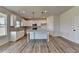 Modern kitchen with white cabinets, granite counters, and large island at 138 Longhorn Way, Auburn, GA 30011