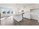 Bright, modern kitchen boasts stainless steel appliances, granite countertops, and a spacious island at 3254 Durston Ct, Dacula, GA 30019
