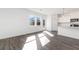 Bright, open-concept living area features hardwood floors, large windows, and seamless flow into the kitchen at 3254 Durston Ct, Dacula, GA 30019