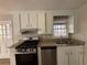 Kitchen with white cabinets, granite countertops, and stainless steel appliances at 3725 Linwood Way, Snellville, GA 30039