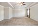 Spacious main bedroom with carpeted floors and ceiling fan at 6094 Whitetail Deer Run, Mableton, GA 30126