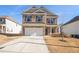 Two-story brick home with a white garage door and landscaping at 6094 Whitetail Deer Run, Mableton, GA 30126