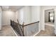 Upstairs hallway with carpeted floors and iron railing at 6094 Whitetail Deer Run, Mableton, GA 30126