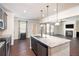 Open kitchen island with granite countertops and stainless steel appliances at 6094 Whitetail Deer Run, Mableton, GA 30126