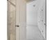 Hallway features a bathroom with glass shower doors and white doors and trim at 3250 Durston Ct, Dacula, GA 30019