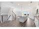 Large, open-concept living space featuring a kitchen with an island and stairs to the upper level at 3250 Durston Ct, Dacula, GA 30019