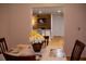 Dining area with table and chairs, offering a view of the living room at 5958 King Way Walk, Lithonia, GA 30058