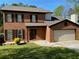 Brick two-story house with a two-car garage and landscaping at 5958 King Way Walk, Lithonia, GA 30058