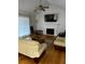 Spacious living room featuring hardwood floors, a fireplace, and large TV at 5958 King Way Walk, Lithonia, GA 30058