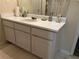 Bathroom sink with white cabinetry, a mirror, and lots of counter space at 6603 Biscayne Blvd, Rex, GA 30273