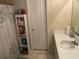 Bathroom sink with white cabinetry, shelf, shower with a curtain at 6603 Biscayne Blvd, Rex, GA 30273