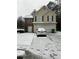 Two-story house with stone and vinyl siding, snow covered lawn, attached garage at 6603 Biscayne Blvd, Rex, GA 30273