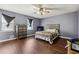 Main bedroom with dark hardwood floors and neutral walls at 10342 Beta Ct, Jonesboro, GA 30238