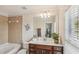 Bathroom with a single vanity, bathtub, and window at 2367 Millhaven Se St # 15, Smyrna, GA 30080