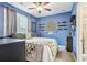Bedroom with blue walls and ceiling fan at 2367 Millhaven Se St # 15, Smyrna, GA 30080