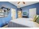 Blue bedroom with a large bed and TV at 2367 Millhaven Se St # 15, Smyrna, GA 30080