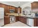 Well-equipped kitchen with dark wood cabinets and granite countertops at 2367 Millhaven Se St # 15, Smyrna, GA 30080