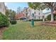 Green grassy area with trees and a trash can at 2367 Millhaven Se St # 15, Smyrna, GA 30080