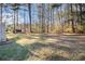 Grassy backyard featuring mature trees, a shed and lots of space at 3472 Honeycomb Se Dr, Conyers, GA 30094